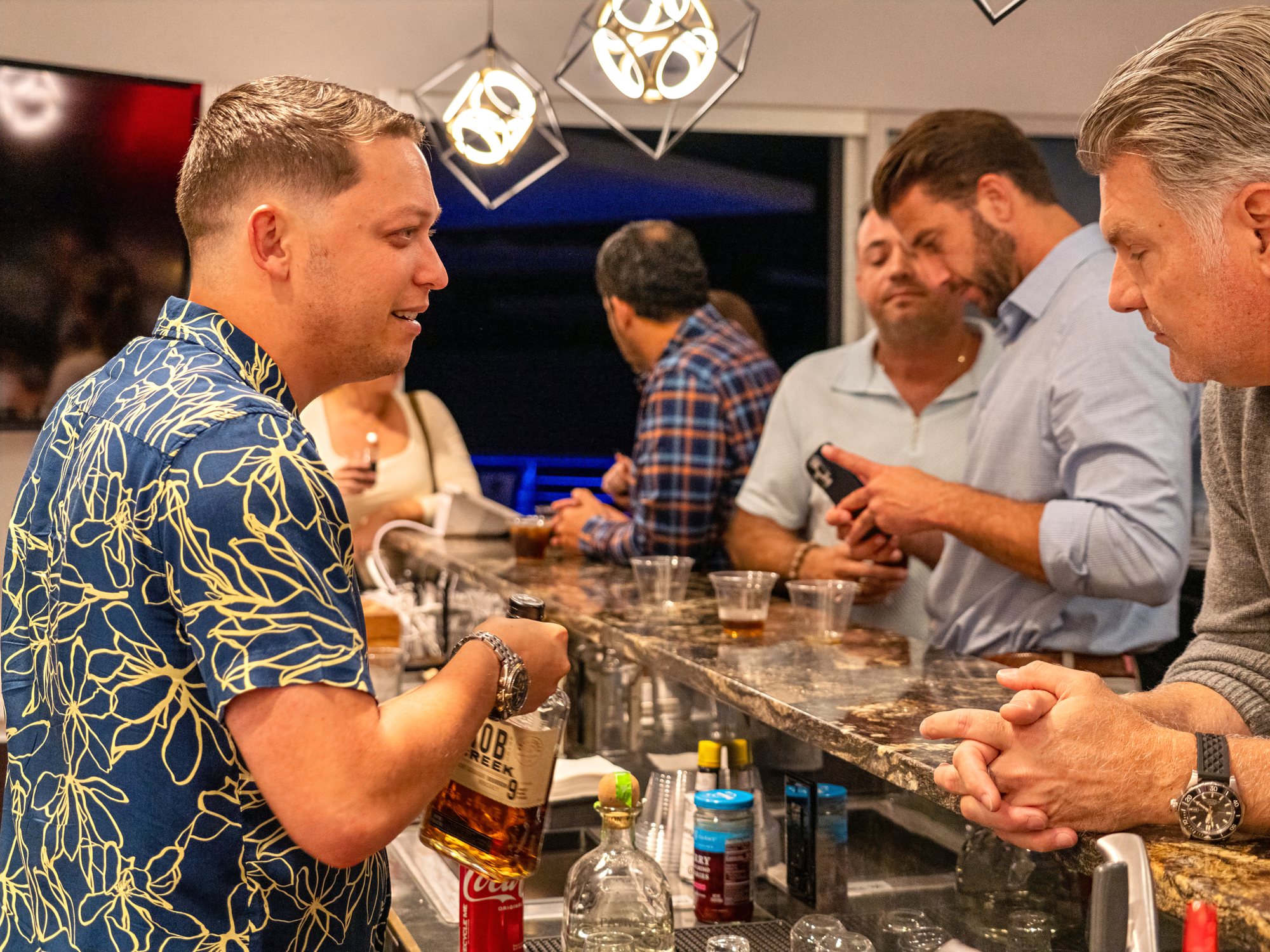 Members talking at the bar